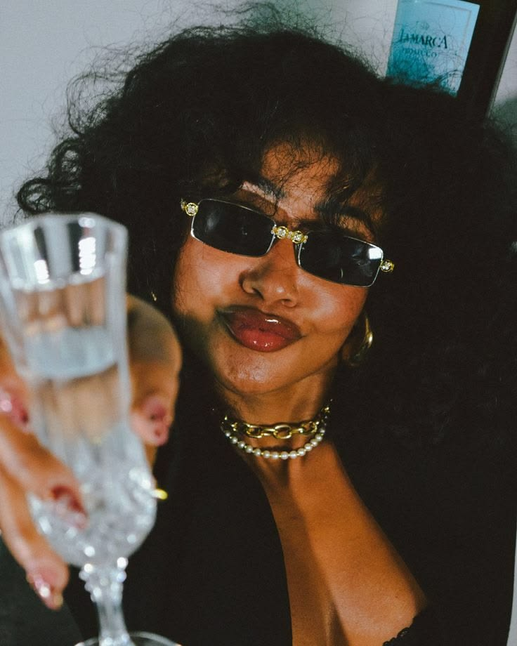 Stylish woman raising a glass